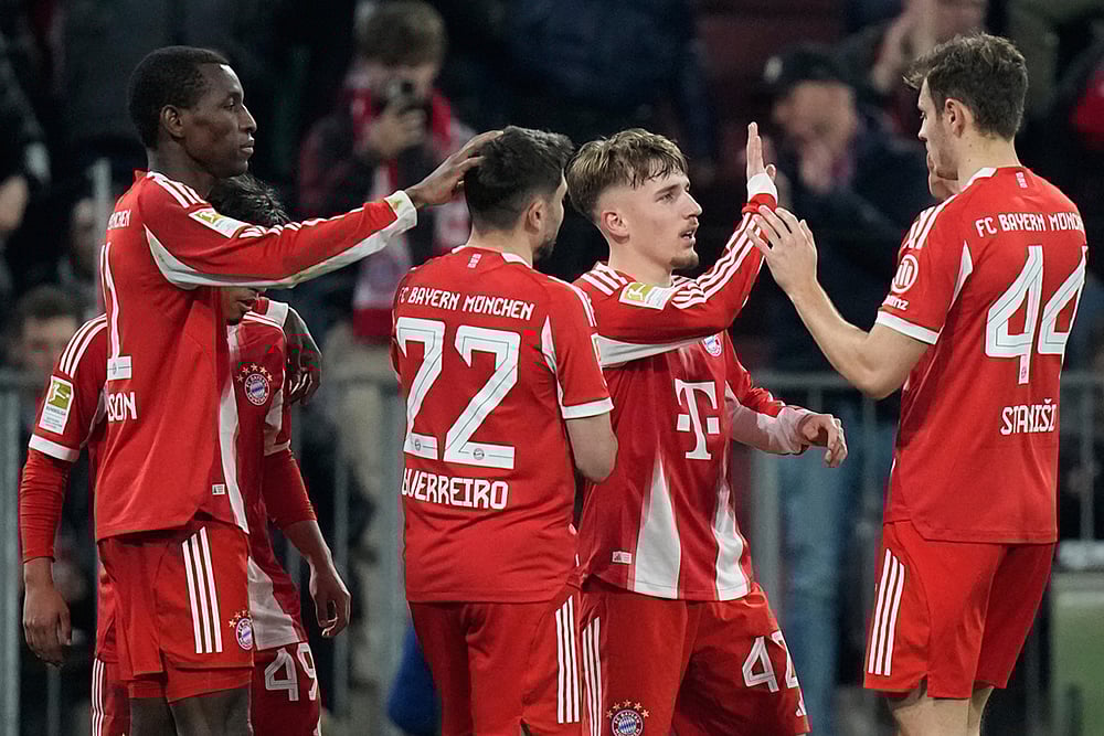 | Photo: AP/Matthias Schrader : Bayerns Nicolas Jackson, left, celebrates with team mates Raphael Guerreiro (22), Lennart Karl (42) and Josip Stanisic (44) after scoring his sides fourth goal during the Bundesliga soccer match between FC Bayern Munich and Borussia Moenchengladbach in Munich, Germany.