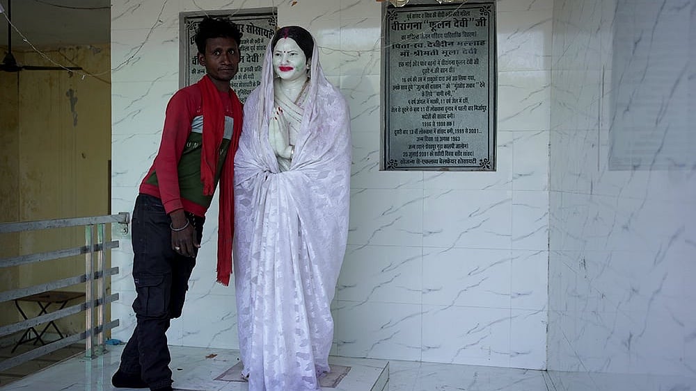 | Photo:  Animikh Chakrabarty/Outlook : Anmol, a local villager takes us to the house of Phoolan Devi in Shekhpur Guda. As he unveils the Statue from its “ghoongat”, he stops to pose with it for the camera