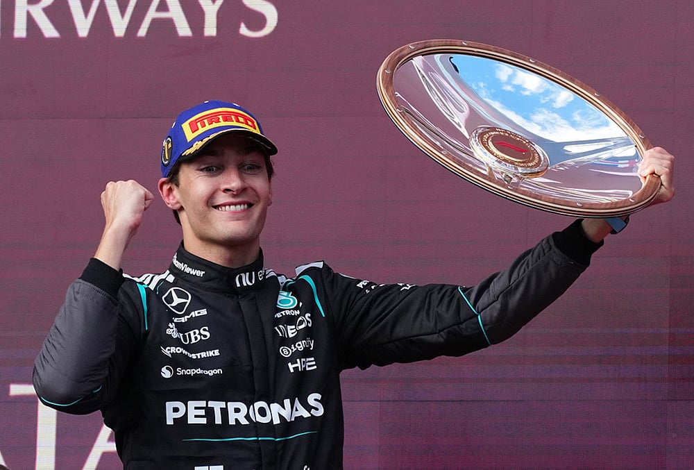 | Photo: AP/Scott Barbour : Mercedes driver George Russell of Britain celebrates after winning the Australian Formula One Grand Prix at Albert Park, in Melbourne, Australia.