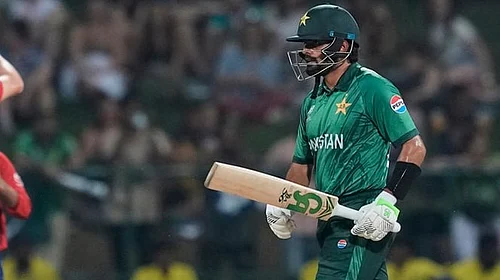 | Photo: AP/Eranga Jayawardena : Pakistans Babar Azam leaves the ground after losing his wicket as Englands Jamie Overton, left, celebrates with teammates during the T20 World Cup cricket match between England and Pakistan in Pallekele, Sri Lanka.
