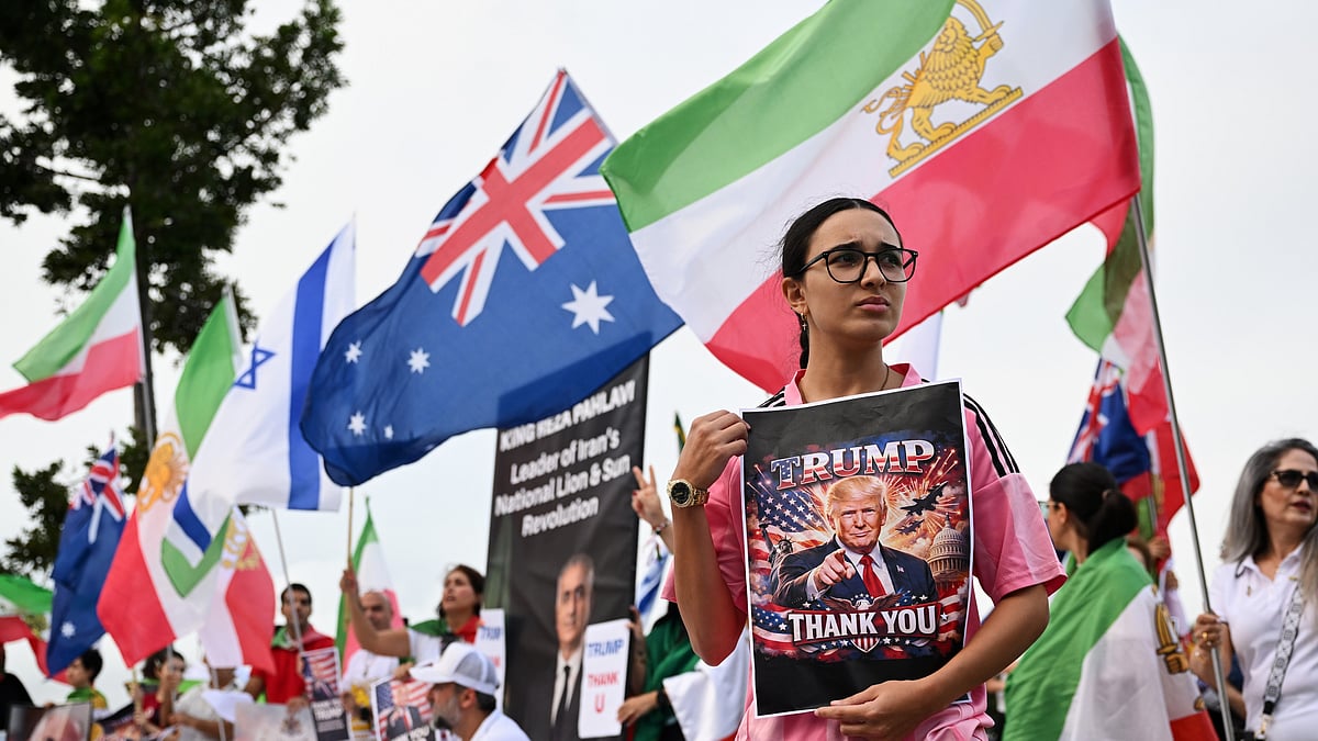 | Photo: AP/DAVE HUNT : Iranians in Australia react with flags and political signs outside the stadium ahead of the Women's Asia Cup soccer match between Australia and Iran in Robina, Australia, Thursday, March 5, 2026. 