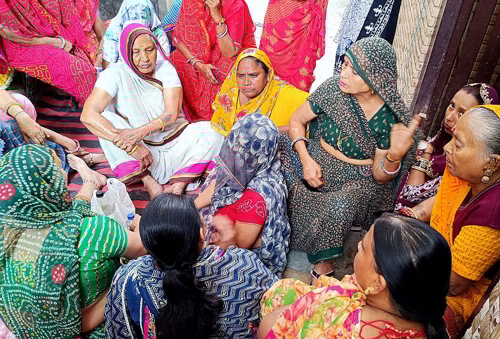 | Photo: Suresh K Pandey/Outlook : Tarun Kumar’s mother, Sunita, sitting outside her home in Uttam Nagar, Delhi, surrounded by women who had come to comfort her after her son’s alleged killing.