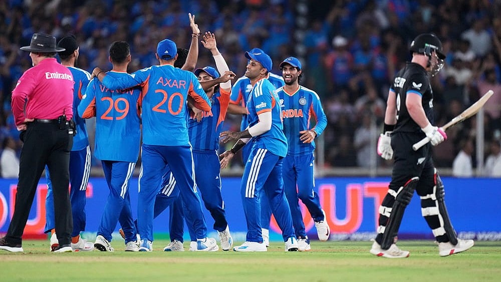 | Photo: AP/Ajit Solanki : Indias players celebrate the wicket of New Zealands Tim Seifert, right, during the T20 World Cup cricket final match between India and New Zealand in Ahmedabad.