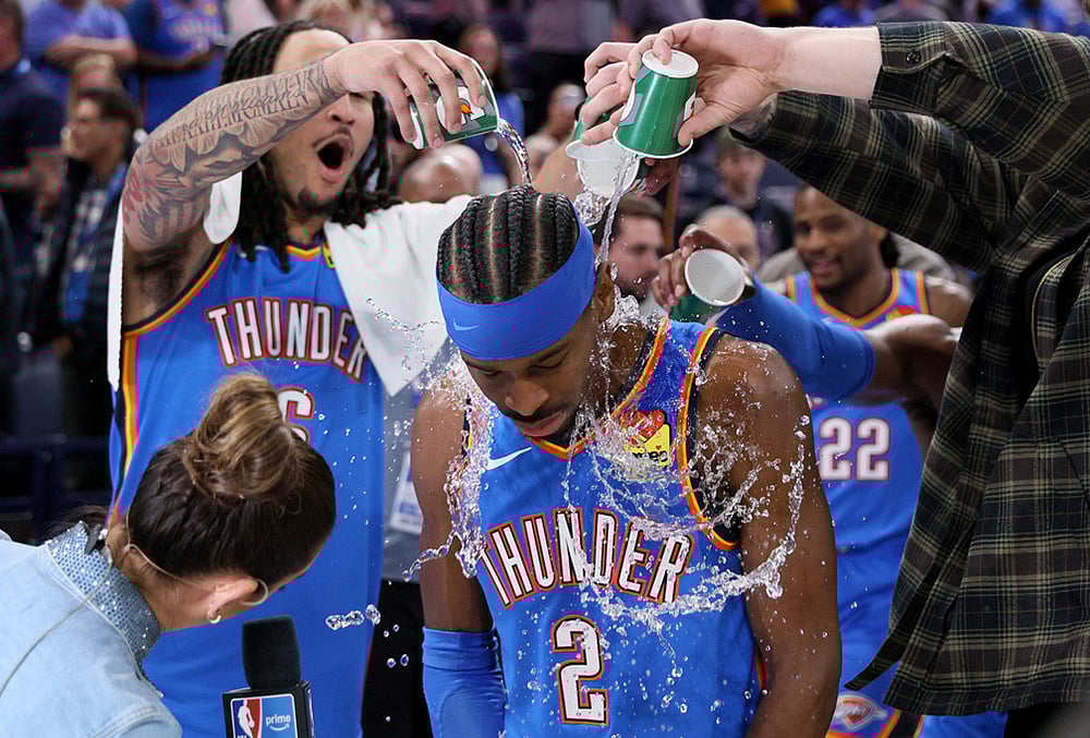| Photo: AP/Nate Billings : Oklahoma City Thunder forward Jaylin Williams, left, and other Thunder players pour water on Thunder guard Shai Gilgeous-Alexander (2) after an NBA basketball game against the Boston Celtics in Oklahoma City. 
