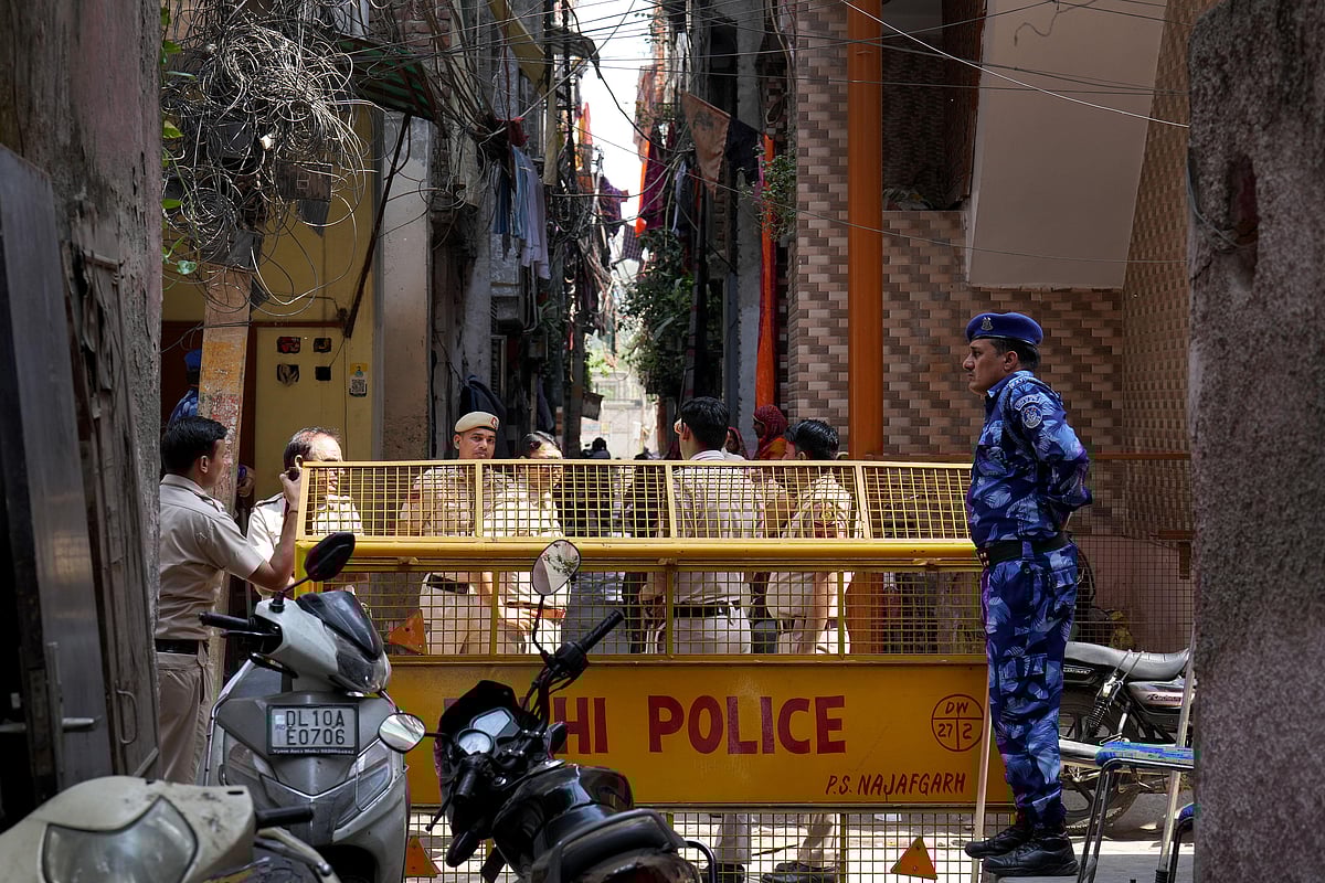 SURESH K PANDEY : Police and CRPF personnel manning the barricades surrounding the houses of Tarun Kumar and the accused.