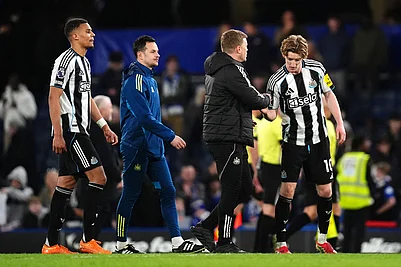 | Photo: John Walton/PA via AP : Newcastle Uniteds Anthony Gordon, right, is congratulated by manager Eddie Howe following victory in the Premier League match between Chelsea and Newcastle, in London.