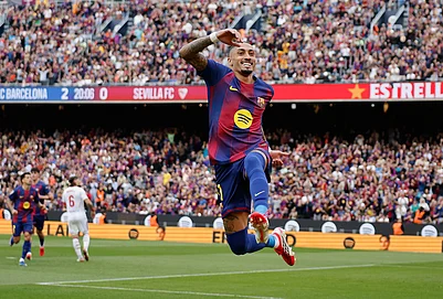 | Photo: AP/Joan Monfort : Barcelonas Raphinha celebrates after scoring during the Spanish La Liga soccer match between Barcelona and Sevilla in Barcelona, Spain