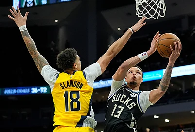 | Photo: AP/Aaron Gash : Milwaukee Bucks Ryan Rollins (13) shoots against Indiana Pacers Jalen Slawson (18) during the second half of an NBA basketball game in Milwaukee.