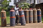 RAHULGROVER : A worker carries LPG cylinders at a distribution centre, in Dehradun, Uttarakhand, Wednesday, March 11, 2026. Long queues were seen at several gas agencies amid an ongoing LPG supply shortage in the country
