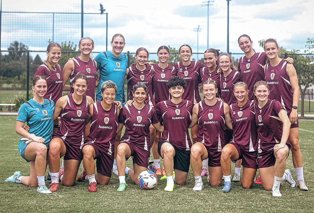 | Photo: Brisbane Roar via AP : Iranian soccer players Fatemeh Pasandideh, fourth from right at front row, and Atefeh Ramezanisadeh, fourth from left at front row, pose for a photo with the Brisbane Roar womens A-League team at a training session in Brisbane, Australia.