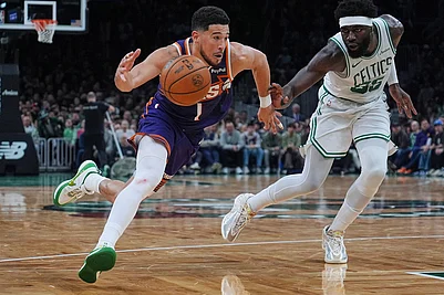 | Photo: AP/Charles Krupa : Phoenix Suns guard Devin Booker (1) drives to the basket against Boston Celtics center Neemias Queta, right, during the second half of an NBA basketball game in Boston.