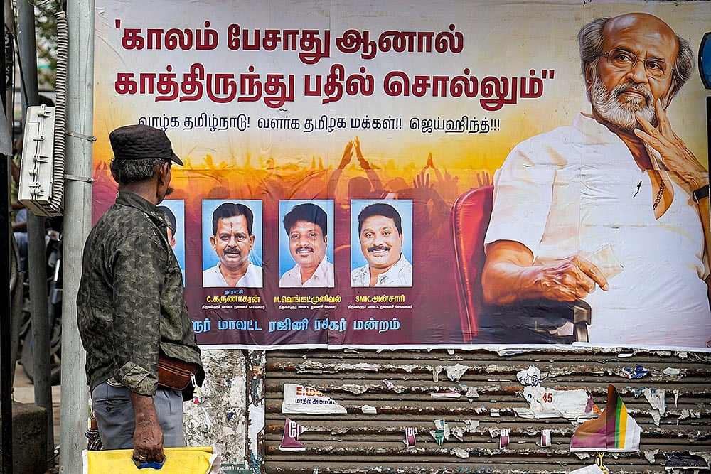 | Photo: PTI/R Senthilkumar : People walk past a wall poster put up by fans of veteran actor Rajinikanth, reflecting his reaction to a recent speech by TVK office-bearer Aadhav Arjuna, in Chennai.