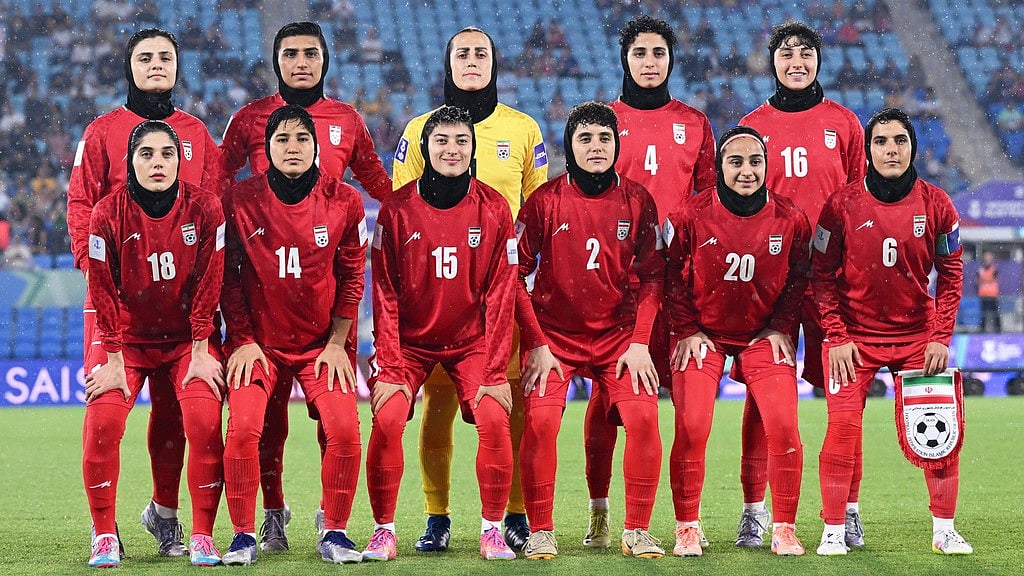 Dave Hunt/AAPImage via AP, File : Iran players pose for a team photo ahead of the Women's Asian Cup match between Iran and the Philippines in Robina, Australia.