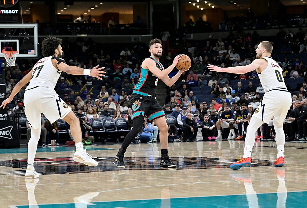 |  Photo: AP/Brandon Dill : Memphis Grizzlies guard Ty Jerome (2) handles the ball between Denver Nuggets guards Jamal Murray (27) and Christian Braun (0) in the second half of an NBA basketball game in Memphis, Tennessee.