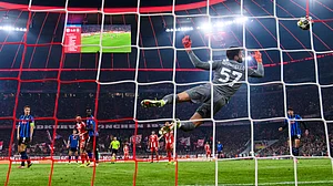 | Photo: AP/Tom Weller : Bayern Munich's Harry Kane scores to make it 2-0 against Atalanta Bergamo's Marco Sportiello, Wednesday, March 18, 2026, in Munich, Germany.