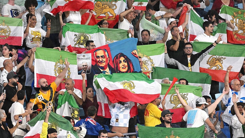 AP : Iran supporters wave flags and hold images of Reza Pahlavi, the son of the last Shah of Iran, during the Womens Asian Cup match between Iran and the Philippines in Robina.