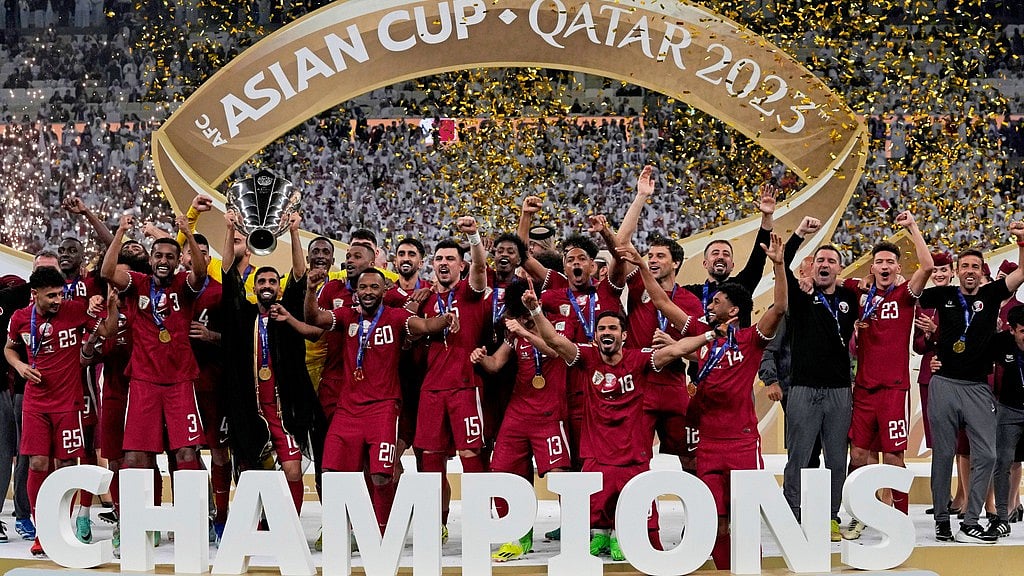 File/AP : The Qatar team poses with the trophy at the end of the Asian Cup 2023 final between Qatar and Jordan at the Lusail Stadium in Lusail.