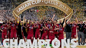 File/AP : The Qatar team poses with the trophy at the end of the Asian Cup 2023 final between Qatar and Jordan at the Lusail Stadium in Lusail.
