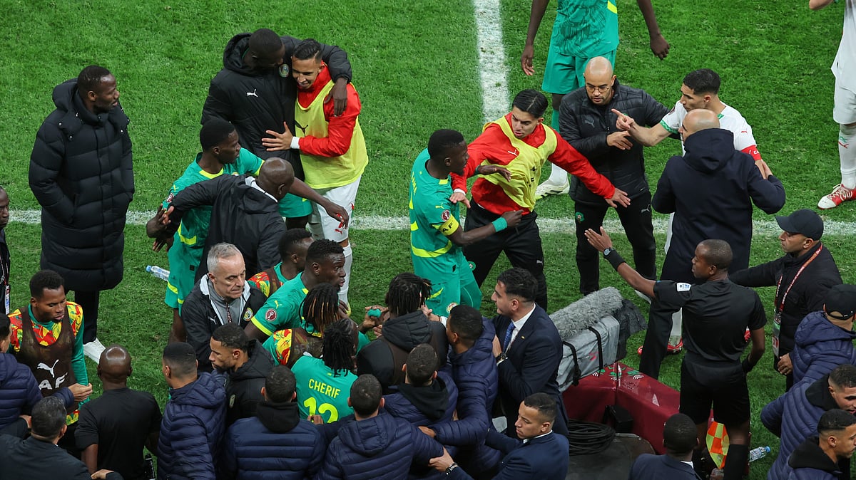 (AP Photo/Youssef Loulidi, File) : FILE - Players from both sides clash after a controversial penalty was awarded to Morocco late on during the Africa Cup of Nations final soccer match between Senegal and Morocco in Rabat, Morocco, Sunday, Jan. 18, 2026.