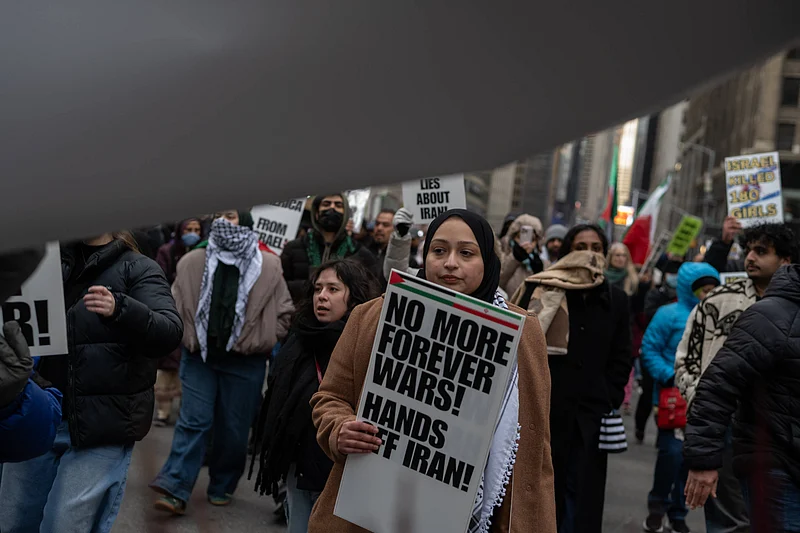 Source: IMAGO / ZUMA Press Wire : March 13, 2026, New York, New York, USA: A woman carries a sign that reads,