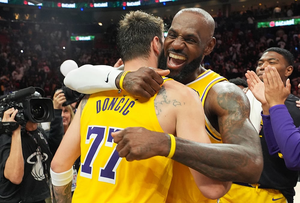 | Photo: AP/Lynne Sladky : Los Angeles Lakers guard Luka Doncic (77) and forward LeBron James, right, embrace after defeating the Miami Heat in an NBA basketball game, in Miami.