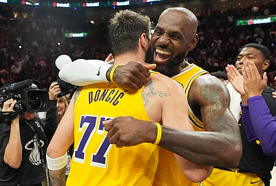 | Photo: AP/Lynne Sladky : Los Angeles Lakers guard Luka Doncic (77) and forward LeBron James, right, embrace after defeating the Miami Heat in an NBA basketball game, in Miami.