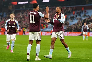 | Photo: David Davies/PA via AP : Aston Villa's Leon Bailey, right, celebrates with his teammate Ollie Watkins after scoring his side's second goal during the Europa League round of sixteen second leg soccer match between Aston Villa and LOSC Lille in Birmingham, England.