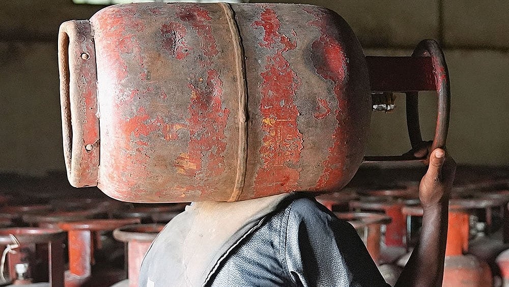 | Photo: Tribhuvan Tiwari : In Short Supply: A man carrying an LPG cylinder at an HP agency in Uttar Pradesh amid the ongoing crisis