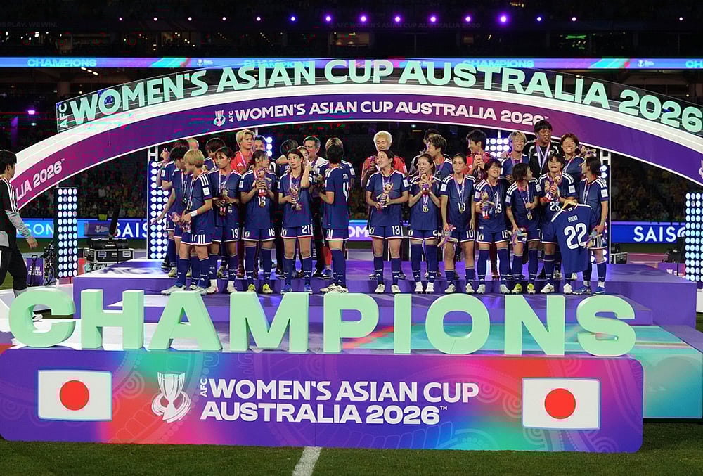 | Photo: AP/Mark Baker : Japanese players pose after winning against Australia at Womens Asian Cup soccer final in Sydney.