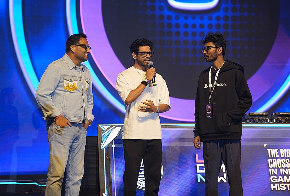 | Photo: Special Arrangement : Founders Gautam Badalia (left) and Santanu Basu (right), alongside event host Ocean Sharma (center), address the crowd at NESCO, Mumbai, during the opening leg of the Indian Super Gaming League (ISGL) city qual