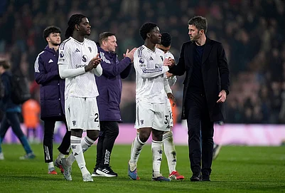 | Photo: Andrew Matthews/PA via AP : Manchester United manager Michael Carrick and Kobbie Mainoo shake hands following an English Premier League soccer match against AFC Bournemouth, in Bournemouth, England.