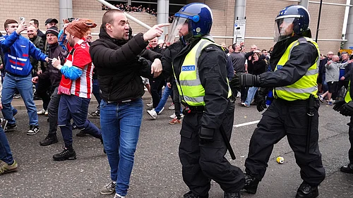 | Photo: AP/Owen Humphreys : Sunderland fans clash with Newcastle United fans as police attempt to intervene before the Premier League match between Newcastle and Sunderland outside St James Park, Newcastle upon Tyne, England, Sunday March 22, 2026.