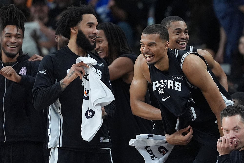 | Photo: AP/Eric Gay : San Antonio Spurs forward Victor Wembanyama, second from right, forward Keldon Johnson, right, and teammates celebrate a play during the second half of an NBA basketball game against the Indiana Pacers in San Antonio.