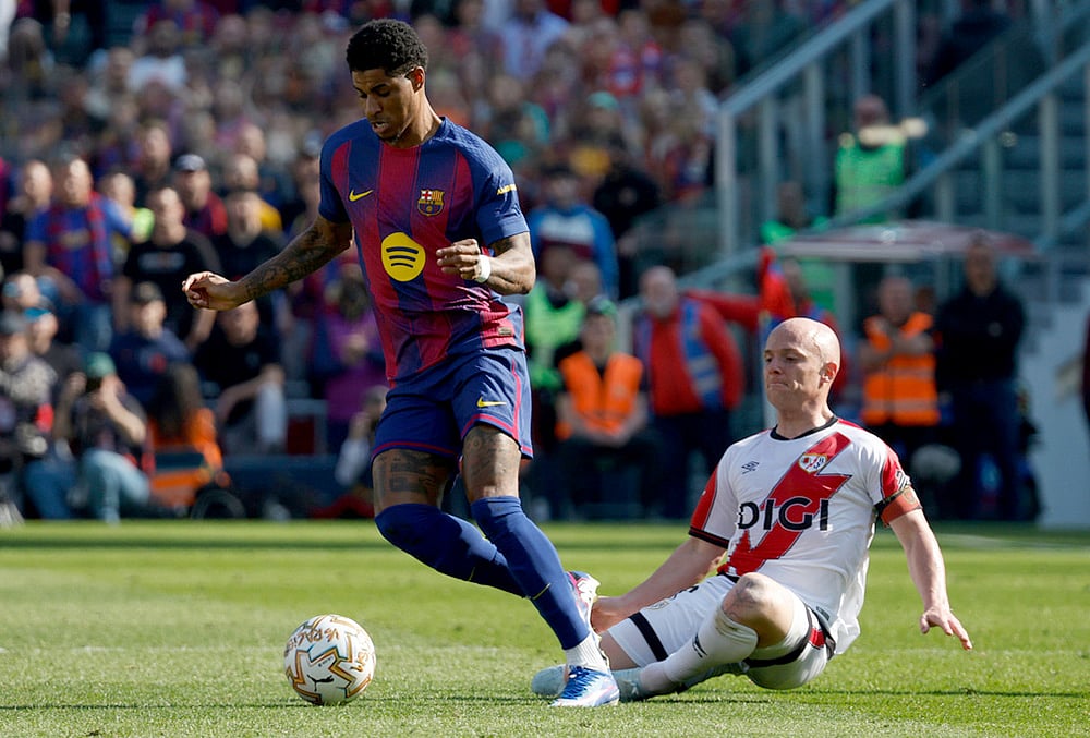 | Photo: AP/Joan Monfort : Barcelonas Marcus Rashford in action in front of Rayos Isi Palazon during a La Liga soccer match between Barcelona and Rayo Vallecano in Barcelona, Spain.