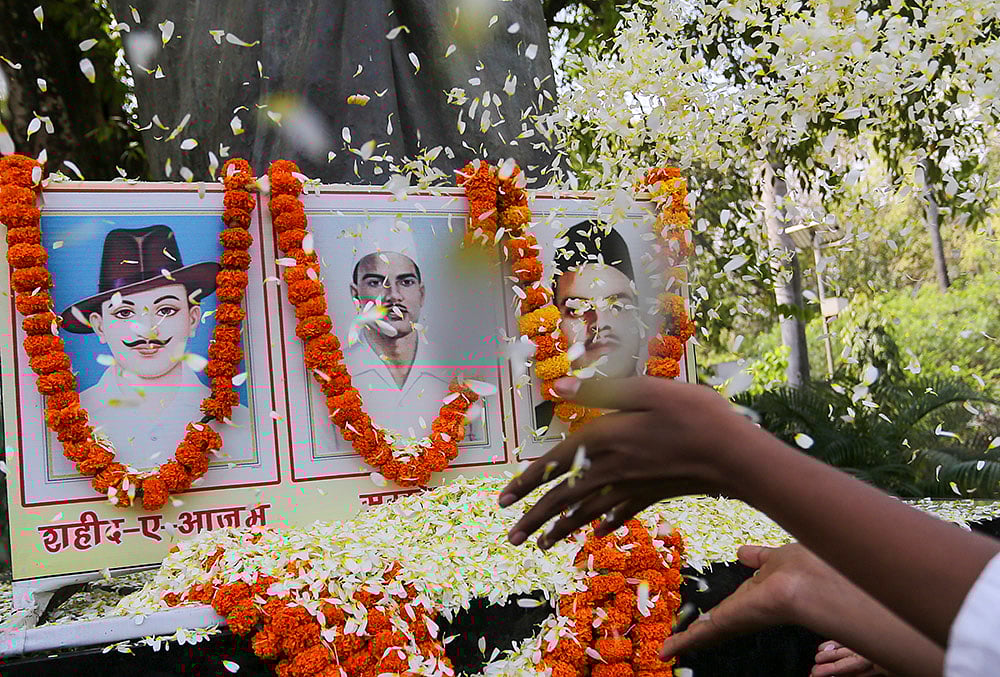 | Photo: PTI : People pay floral tribute to freedom fighters Bhagat Singh, Sukhdev Thapar and Shivaram Rajguru on the Shaheed Diwas, or Martyrs Day, in Prayagraj.