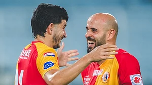 IndSuperLeague/X : East Bengal footballers celebrating a goal against Mohammedan SC in the ISL 2025-26 Kolkata derby clash.