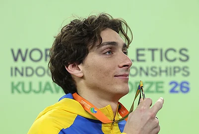 | Photo: AP/Beata Zawrzel : Armand Duplantis, of Sweden, poses on the podium after winning the gold medal in the mens pole vault at the World Athletics Indoor Championships in Torun, Poland.