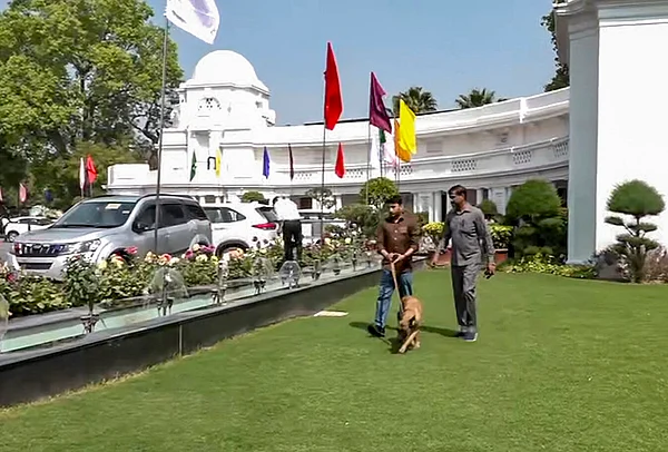 PTI : Security officials with a sniffer dog at the premises of the Delhi Legislative Assembly after it received a bomb threat via an email, in New Delhi.