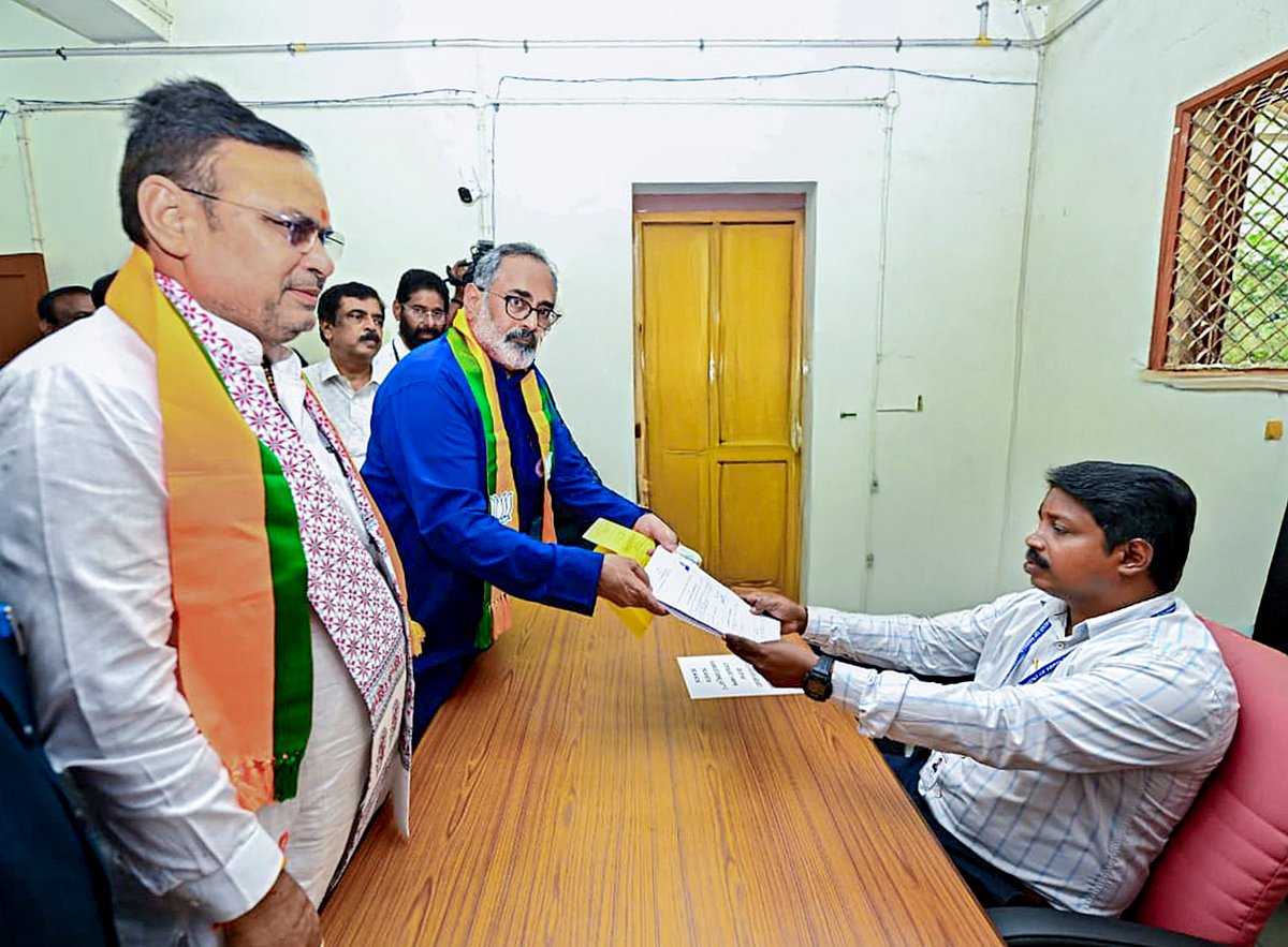 -Source: PTI : In this image posted on March 21, 2026, Rajasthan Chief Minister Bhajanlal Sharma with BJP Kerala President and candidate from Nemom Assembly constituency, Rajeev Chandrasekhar, as the latter files his nomination for state Assembly elections.
