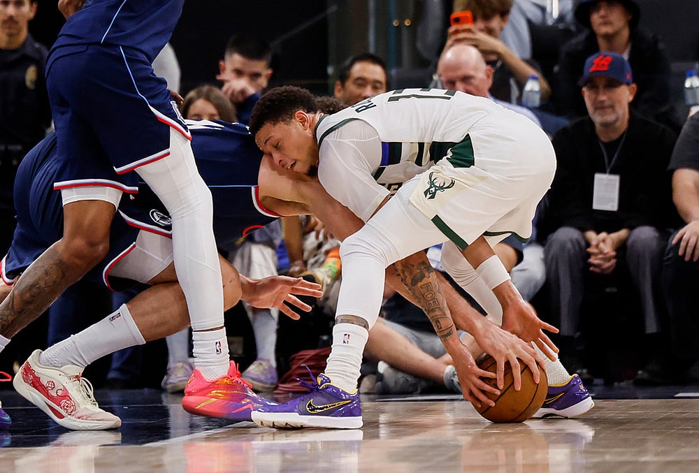 | Photo: AP/Caroline Brehman : LA Clippers center Brook Lopez (11) and Milwaukee Bucks guard Ryan Rollins (13) battle for possession for the ball during the second half of an NBA basketball game in Inglewood, California.