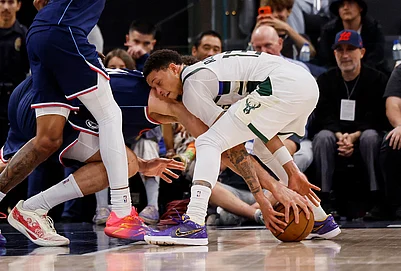| Photo: AP/Caroline Brehman : LA Clippers center Brook Lopez (11) and Milwaukee Bucks guard Ryan Rollins (13) battle for possession for the ball during the second half of an NBA basketball game in Inglewood, California.