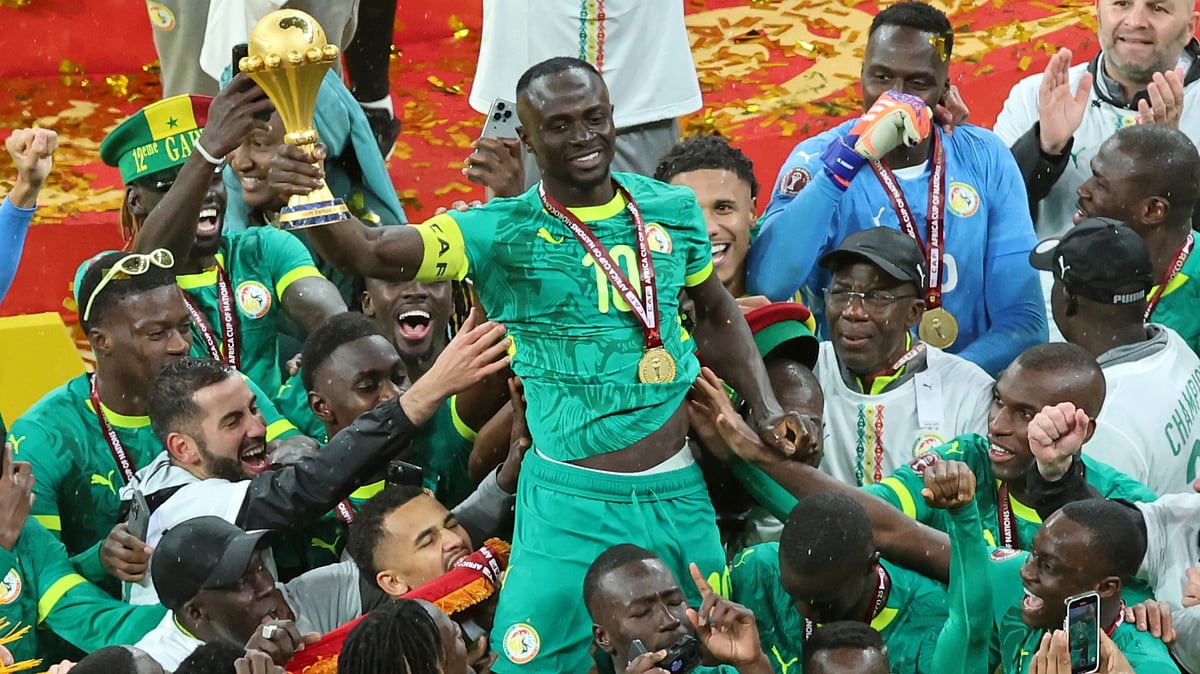 | Photo: AP/Youssef Loulidi : Senegal's Sadio Mane holds the trophy aloft as he celebrates with teammates after winning the Africa Cup of Nations final soccer match between Senegal and Morocco in Rabat, Morocco, Sunday, Jan. 18, 2026. 