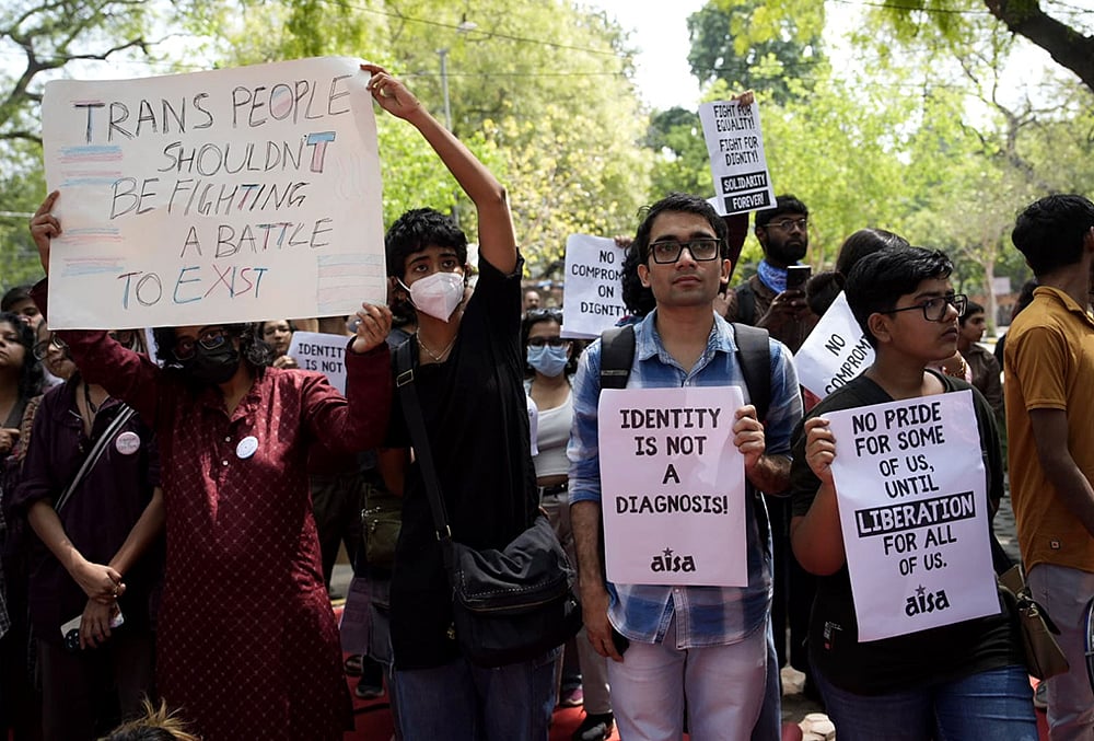 | Photo: Vikram Sharma/Outlook : Supporters of the LGBTQIA+ community hold placards during a protest against the passage of the Transgender Persons (Protection of Rights) Amendment Bill, 2026, at Jantar Mantar in New Delhi.