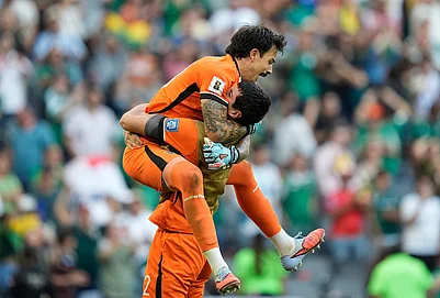 | Photo: AP/Fernando Llano : Bolivias goalkeeper Guillermo Viscarra, top, and goalkeeper Carlos Lampe celebrate at the end of a World Cup playoff semifinal soccer match between Bolivia and Suriname in Monterrey, Mexico.