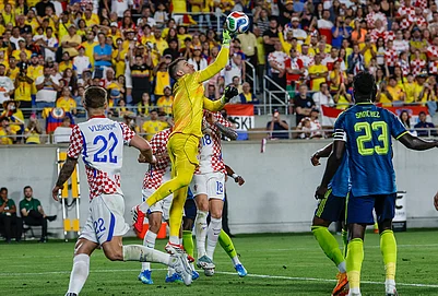 | Photo: AP/Kevin Kolczynski : Croatia goalkeeper Dominik Livakovic, center, punches the ball away from the goal during the second half of an international friendly soccer game in Orlando, Florida.