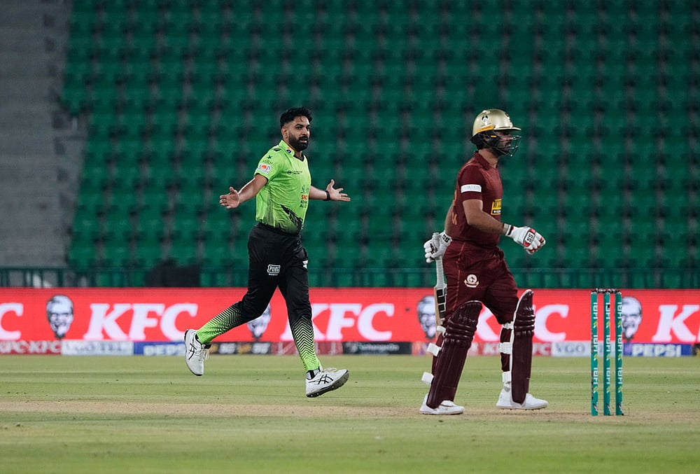 | Photo: AP/K.M. Chaudary : Lahore Qalandars Haris Rauf, left, celebrates after taking the wicket of Hyderabad Kingsmen Hassan Khan, right, during the opening cricket match of the Pakistan Super League between Lahore Qalandars and Hyderabad Kingsmen, which taking place without spectators, in Lahore, Pakistan.