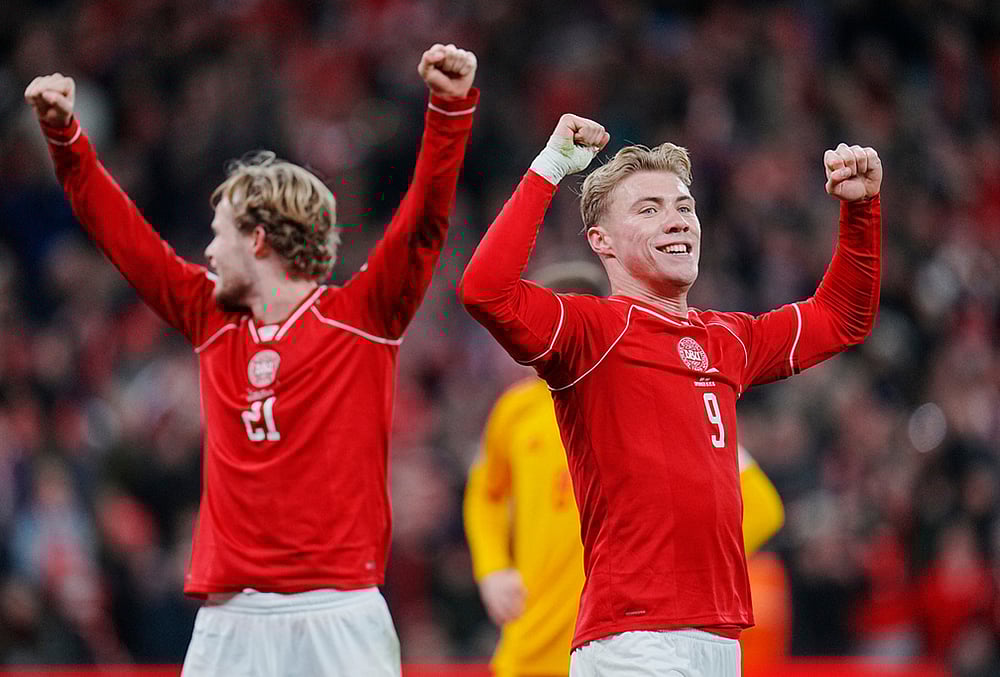 | Photo: Liselotte Sabroe/Ritzau Scanpix via AP : Denmarks Morten Hjulmand, left, and Rasmus Hojlund celebrate during the World Cup playoff semifinal soccer match between Denmark and North Macedonia in Copenhagen. 