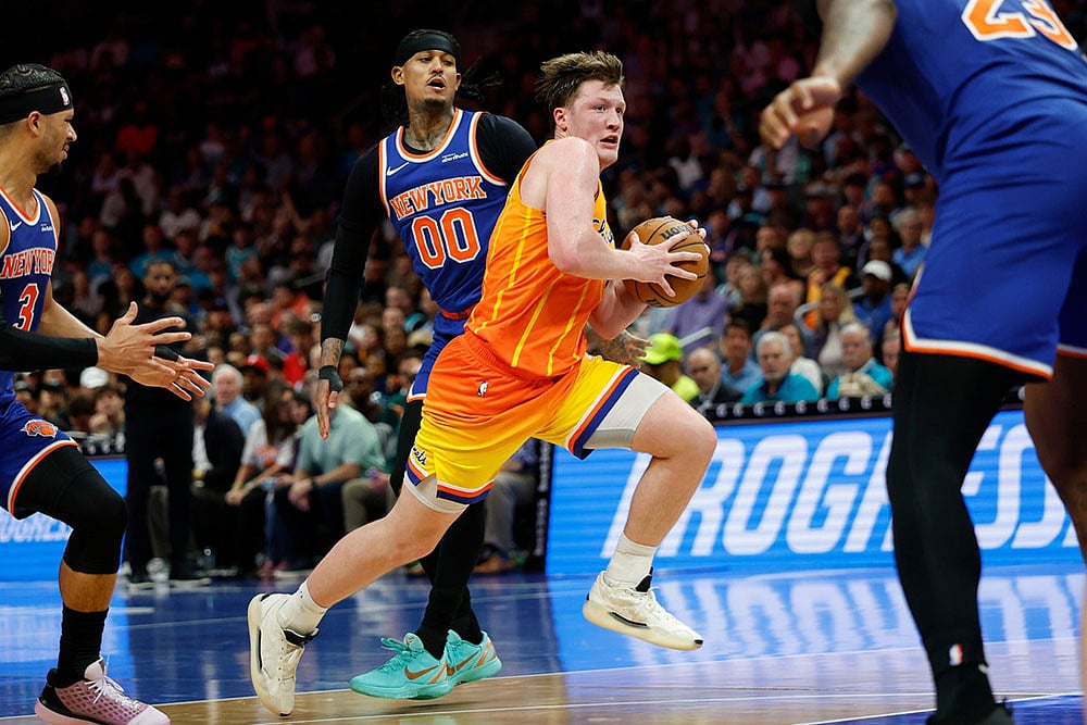 | Photo: AP/Nell Redmond : Charlotte Hornets guard Kon Knueppel, center front, drives to the basket past New York Knicks guards Josh Hart, left, and Jordan Clarkson (00) during the second half of an NBA basketball game in Charlotte, N.C.