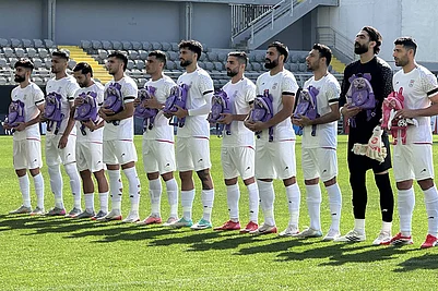 | Photo: IMAGO/Stringer : The Iranian national team, National team players appear at the ceremony wearing black armbands and carrying girls school backpacks to protest the bombing of Shajareh Tayyebeh girls elementary school in Minab and the US-Israel strikes in Iran ahead of the friendly match between Iran and Nigeria at the Mardan Sports Complex in Antalya, Turkiye