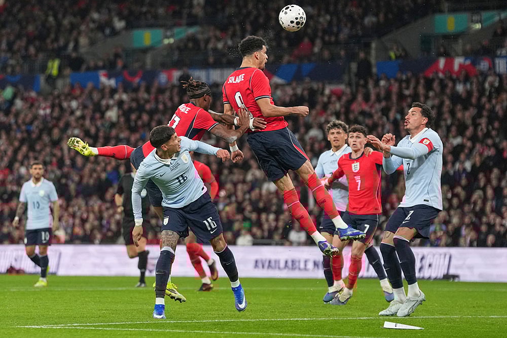| Photo: AP/Alastair Grant : Englands Dominic Solanke heads the ball during the international friendly soccer match between England and Uruguay in London.